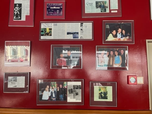 Framed photos and press clippings on the wall of Wellington's oldest cafe