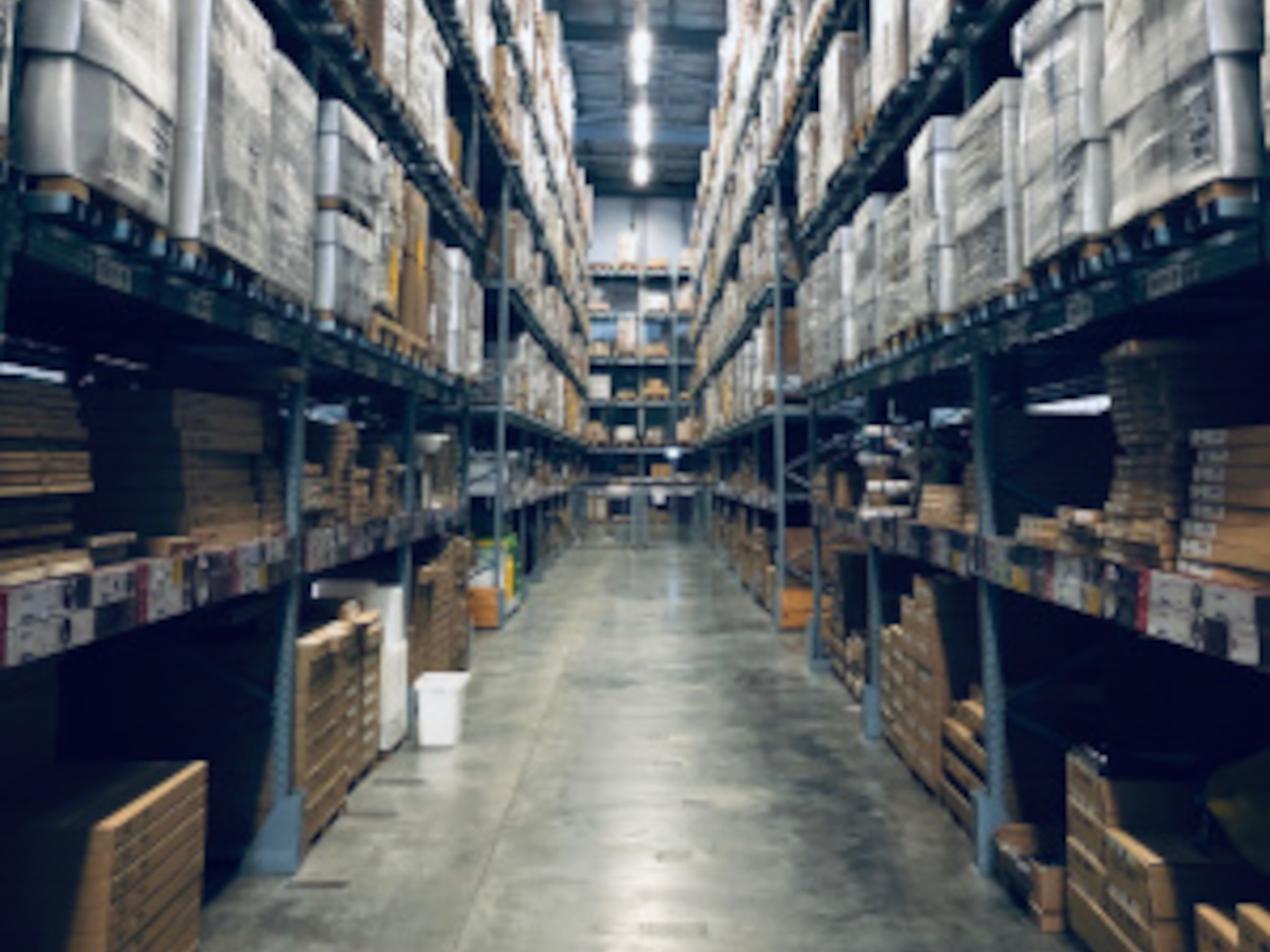 Warehouse shelving stacked with boxed stock, Auckland import and distribution business
