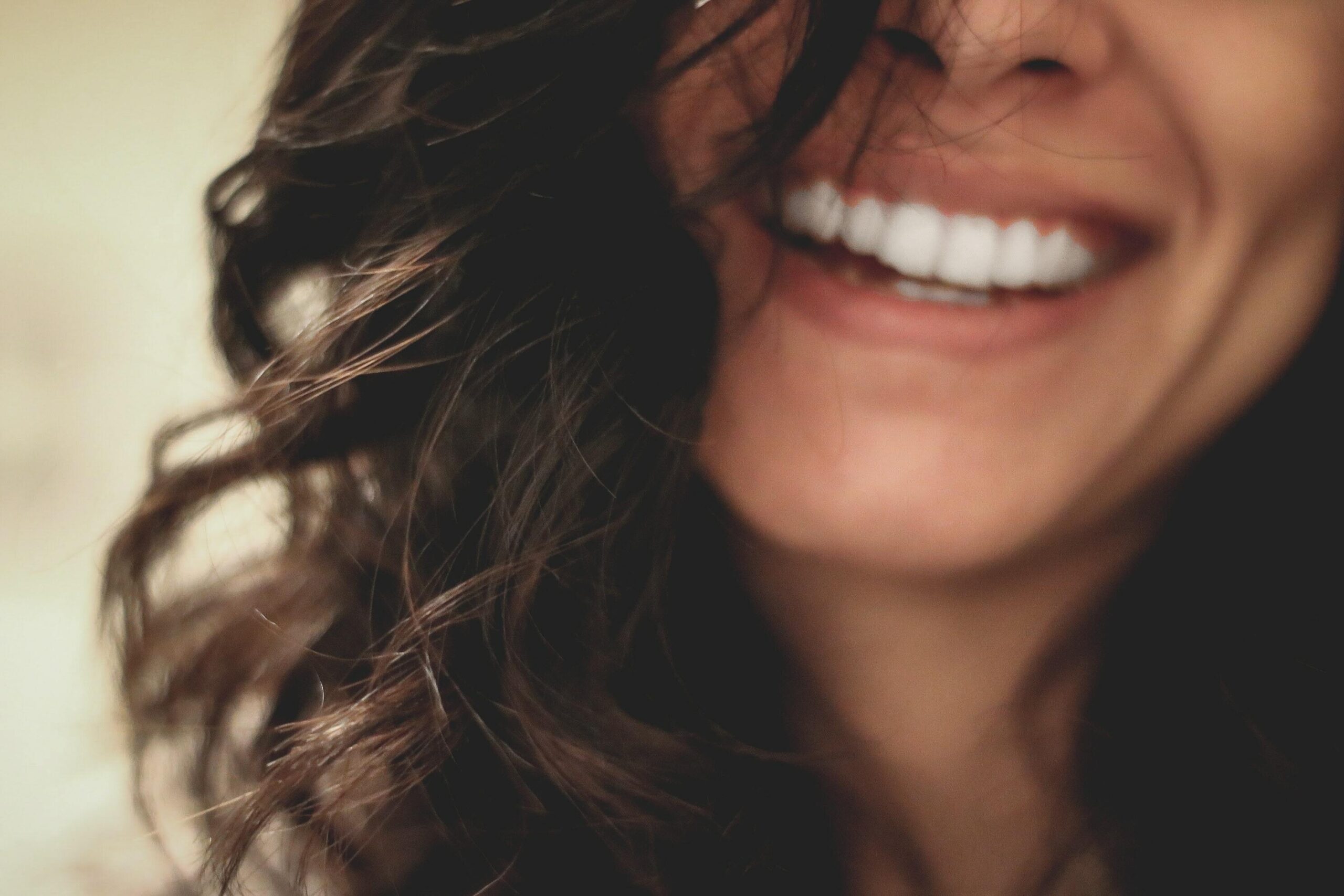 Woman smiling with healthy skin, CACI clinic skin and appearance treatment