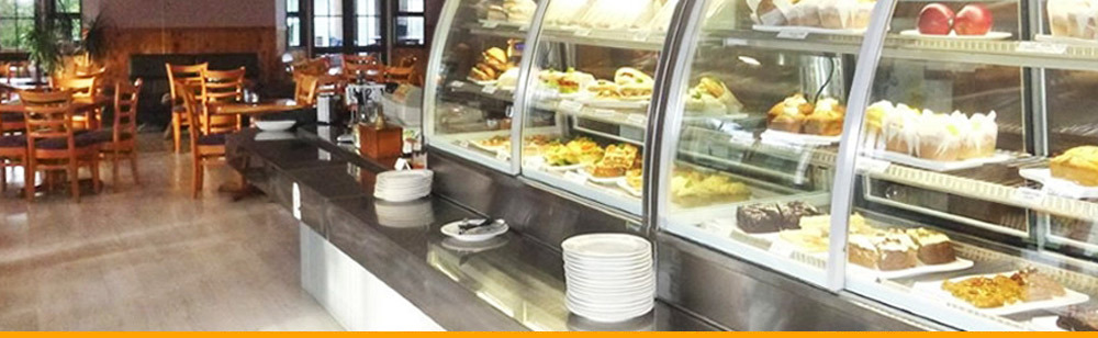 Coffeepot Cafe display cabinet with baked goods and dining area